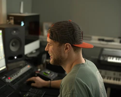Two people sitting in a studio recording a podcast